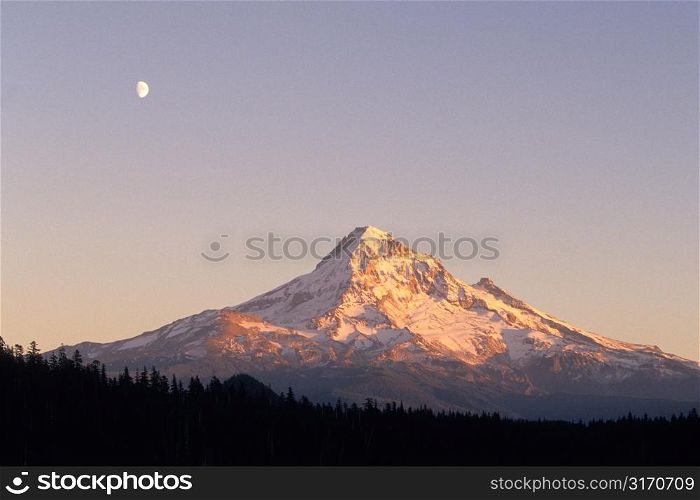 Mountain Peak With A Moon In The Sky