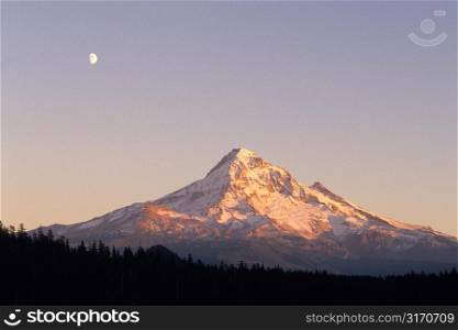 Mountain Peak With A Moon In The Sky