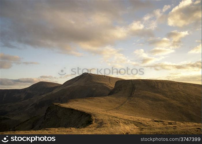 Mountain peaks in the autumn evening sky with clouds