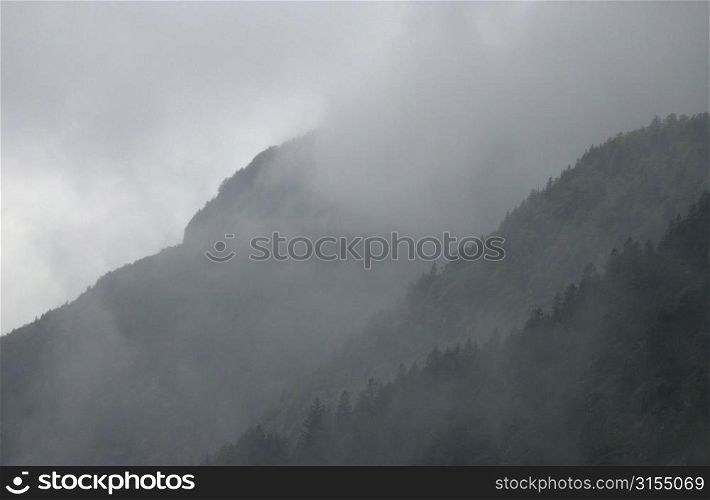 Mountain range surrounded by fog in Slovenia