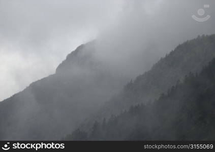 Mountain range surrounded by fog in Slovenia