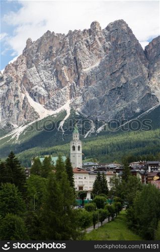 Mountain Ridge in Italian Dolomites Alps, Trees and Typical Houses in Cortina d'Ampezzo, Italy. Mountain Ridge in Italian Dolomites Alps, Trees and Typical Hous