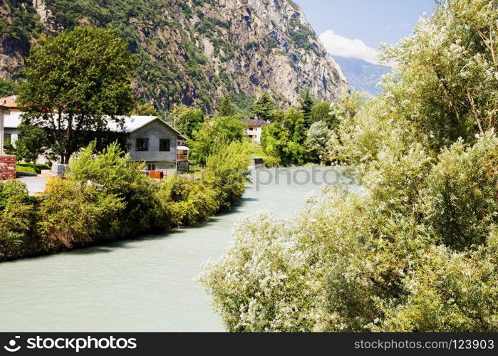 Mountain river landscape, with houses and trees, horizontal image