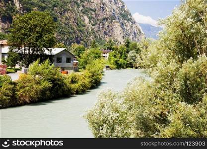 Mountain river landscape, with houses and trees, horizontal image
