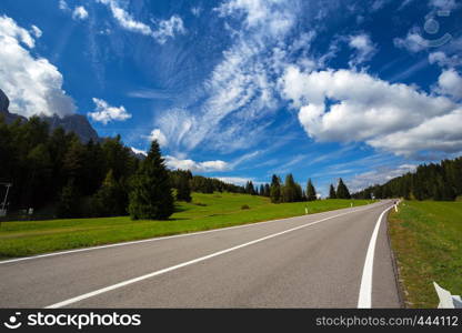 Mountain road and blue sky at the mountains Dolomites, Italy