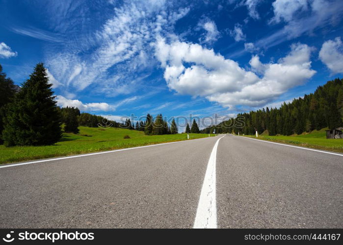 Mountain road and blue sky at the mountains Dolomites, Italy