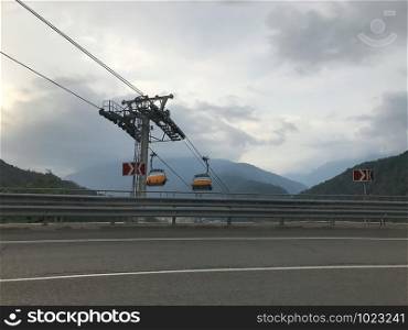 Mountain road and cable car in Caucasus mountains. Sochi, Russia