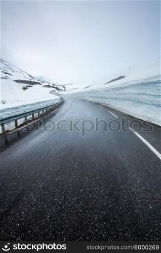 Mountain road in Norway, around the fog and snow.