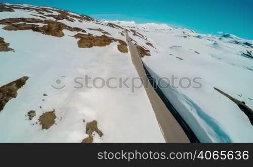 Mountain road in Norway with high snow wall