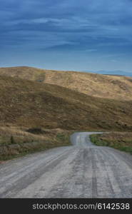 Mountain road in the autumn day