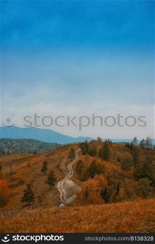 Mountain road in the autumn day in Altay, Siberia, Russia