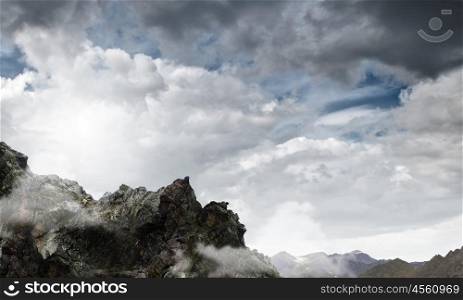 Mountain scene. Abstract image of mountain landscape and floating clouds