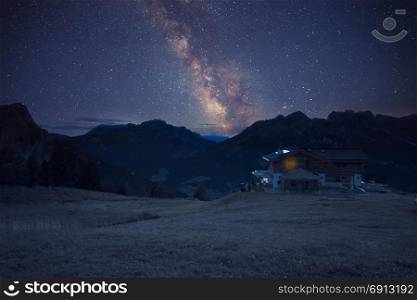 Mountain shelter under starry night sly