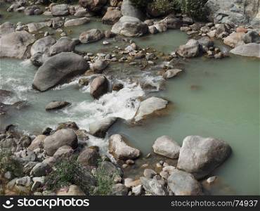 mountain torrent river. mountain torrent river with green water and stones