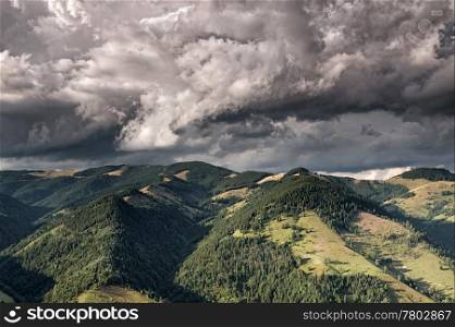 Mountain valley with dark rain clouds. Carpathian mountains, Ukraine