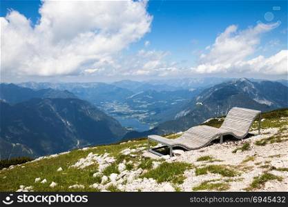 Mountain view with wooden bench on the top. The alpine mountain view, Austria.