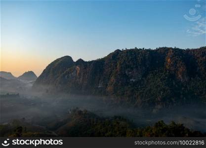 Mountain views and mist flowing through the gorge, clear sky. Mea Usu Cave, Tak in Thailand.