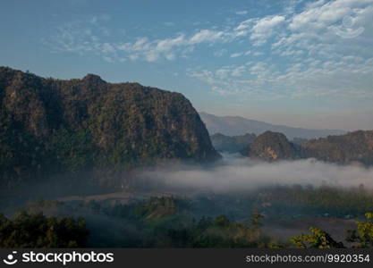 Mountain views and mist flowing through the gorge, clear sky. Mea Usu Cave, Tak in Thailand.