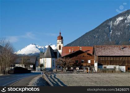 Mountain village in the Alps with church in the foreground