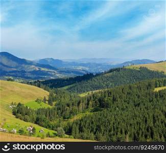 Mountain village. Summer country landscape with fir forest on slope (Carpathian, Ukraine, Verkhovyna district, Ivano-Frankivsk region).