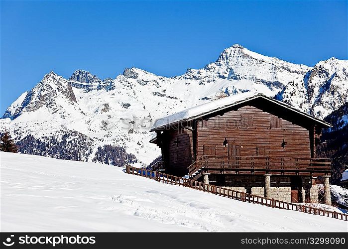 Mountain wooden vacation house over snowed mountain scenic landscape in winter season, West alps, Valle d&acute;aosta, Italy, Europe
