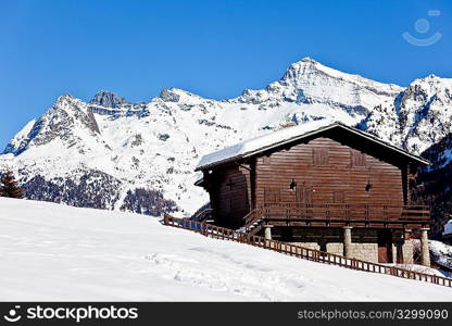 Mountain wooden vacation house over snowed mountain scenic landscape in winter season, West alps, Valle d&acute;aosta, Italy, Europe