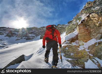 Mountaineer during a winter climb; horizontal frame. Italian alps.