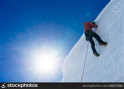Mountaineering sport. Low angle view of man climbing glacier