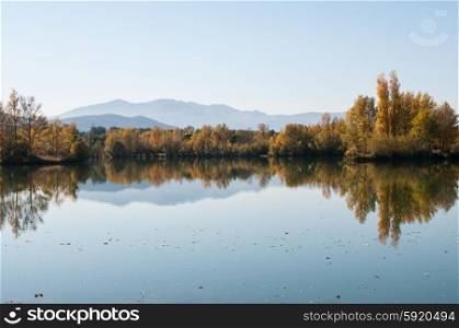 Mountains and autumnal colour reflected in water