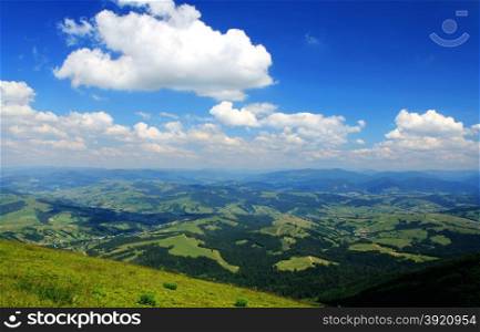 Mountains and blue cloudy sky. Carpathians. Ukraine.. Mountains
