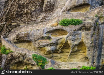 Mountains and cliffs rocky formations with stairs going up to monastery, Thessaly Greece.. Cliffs rocky formations with stairs in Greece Meteora