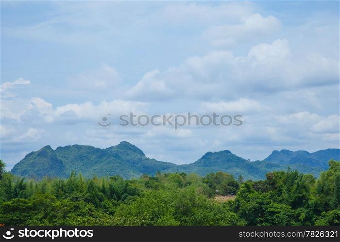 Mountains and forests. Sky covered with clouds. Natural fertility of the country.