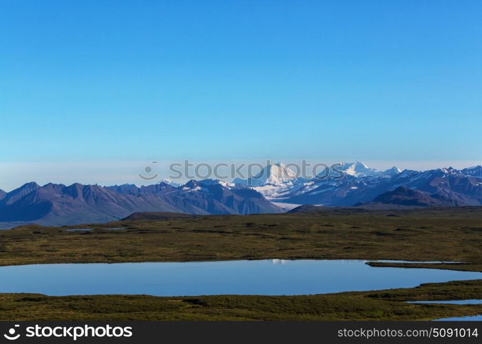 Mountains in Alaska. Picturesque Mountains of Alaska in summer. Snow covered massifs, glaciers and rocky peaks.