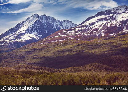 Mountains in Alaska. Picturesque Mountains of Alaska in summer. Snow covered massifs, glaciers and rocky peaks.