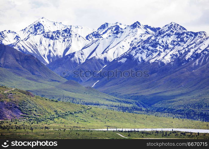 Mountains in Alaska. Picturesque Mountains of Alaska in summer. Snow covered massifs, glaciers and rocky peaks.