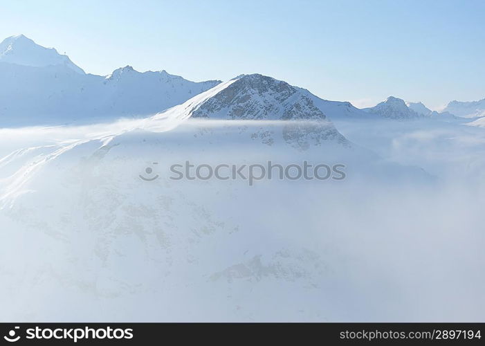 Mountains in clouds with snow in winter, Val-d&acute;Isere, Alps, France