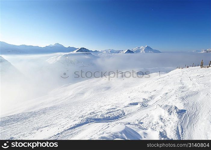 Mountains in clouds with snow in winter, Val-d&acute;Isere, Alps, France