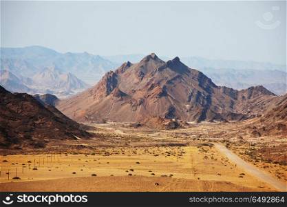 Mountains in Namibia. Colorful landscapes of the orange rocks in the mountains in Namibia on a sunny hot day.