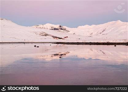 Mountains in Snaefellsnes peninsula reflected in the water at sunset in winter, Iceland. Mountains in Snaefellsnes peninsula at sunset, Iceland