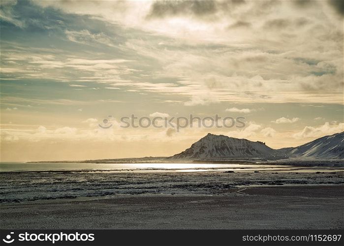 Mountains in Snaefellsnes peninsula with the sun reflected in the water, Iceland. Mountains with the sun reflected in the water, Iceland