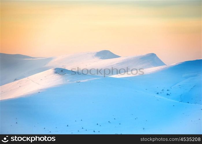 Mountains in snow. Landscape with sunset over hills
