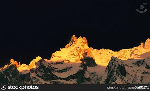 Mountains of snow in the Swiss Alps colored by the setting sun