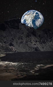 mountains on the moon overlooking planet earth. This image elements furnished by NASA