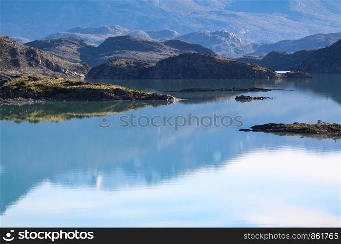 Mountains reflected on surface of blue lake
