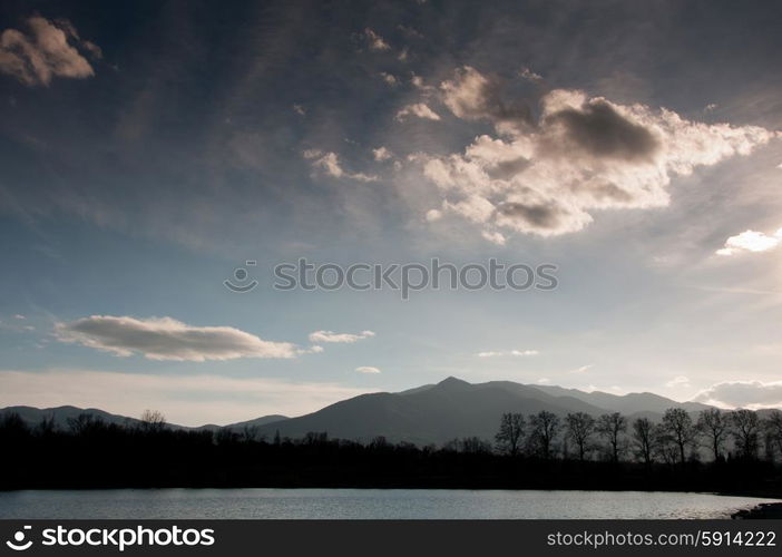 Mountains silhouetted against a cloudy sky