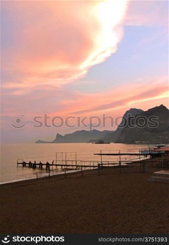 mountains, the sea, sandy beach at sunset