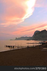 mountains, the sea, sandy beach at sunset