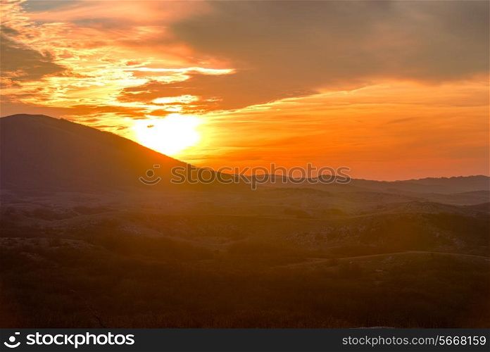 Mountains with and dramatic colorful sky at sunset