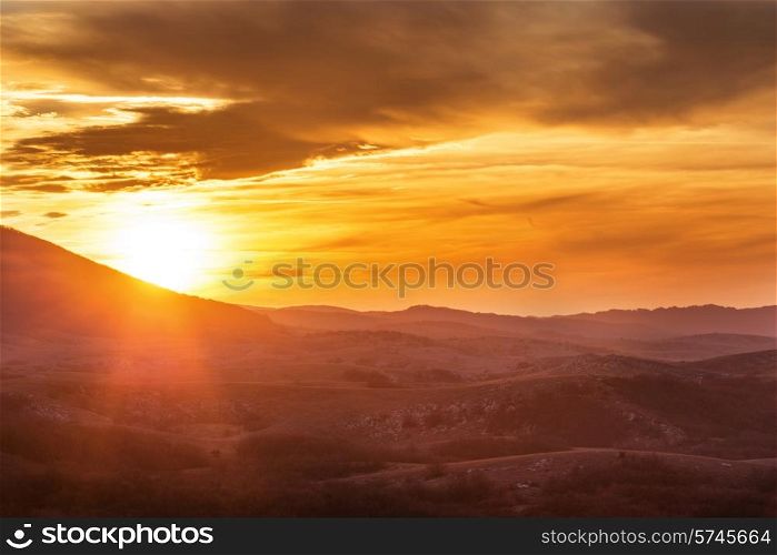 Mountains with and dramatic colorful sky at sunset