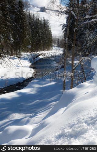 Mountains with Snow-covered Fir Trees, and Creek of Frozen Water.. Mountains with Snow-covered Fir Trees, and Creek of Frozen Water